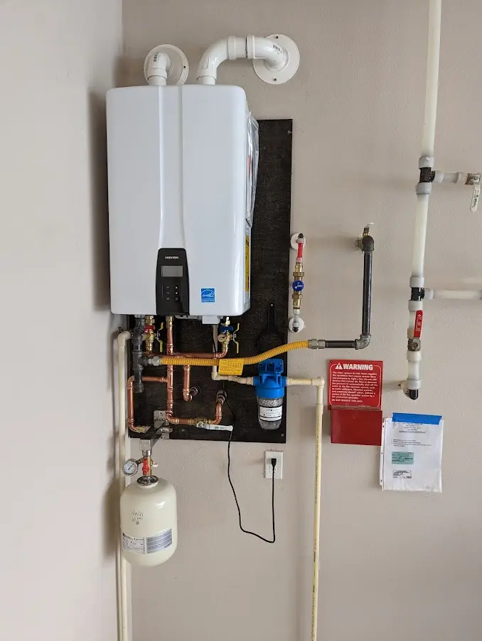 Professional plumber installing copper piping in a Pevely home